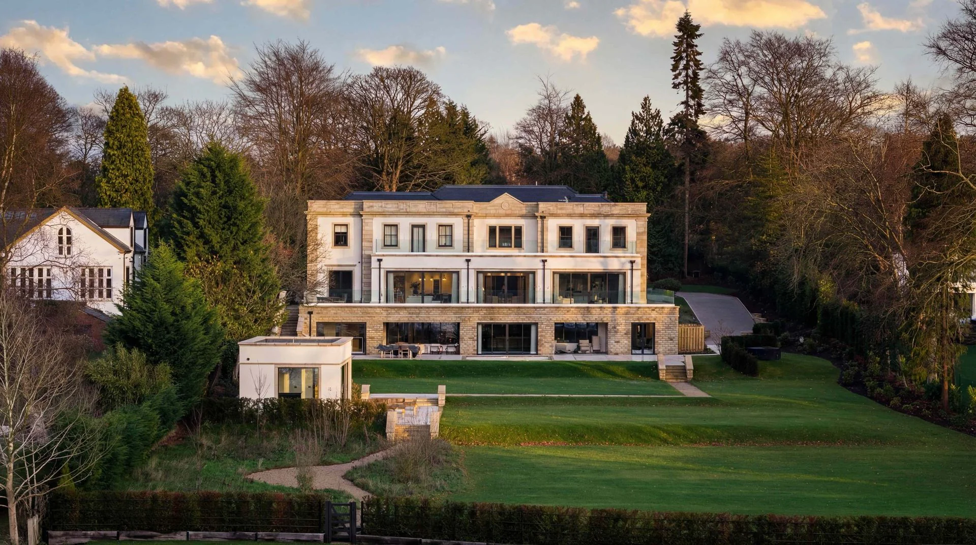 Stone country house and lawn at golden hour