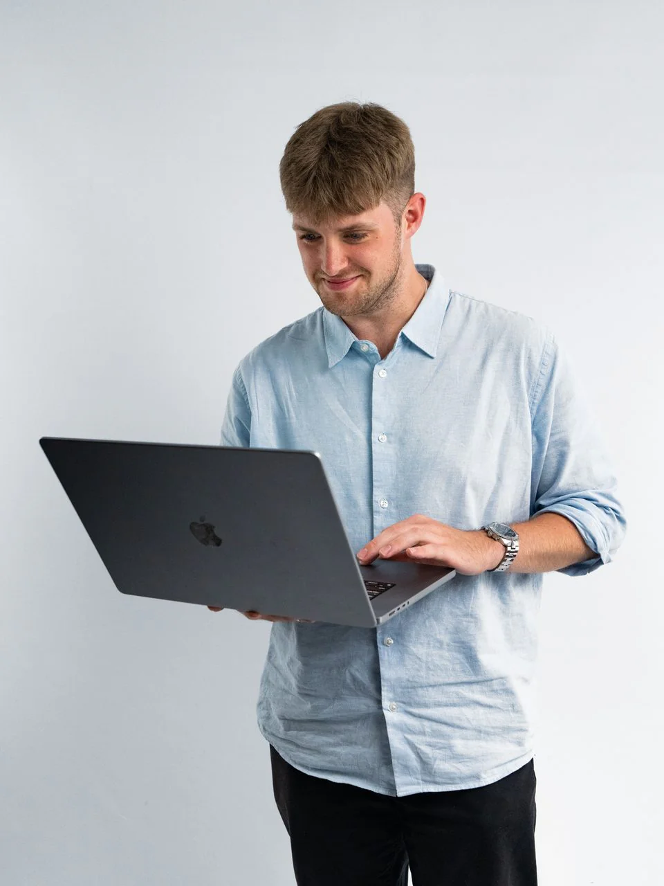 Paid ads specialist working on a laptop he is holding