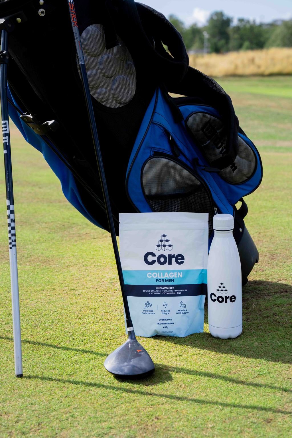 Supplement pouch and water bottle beside a golf bag on a fairway