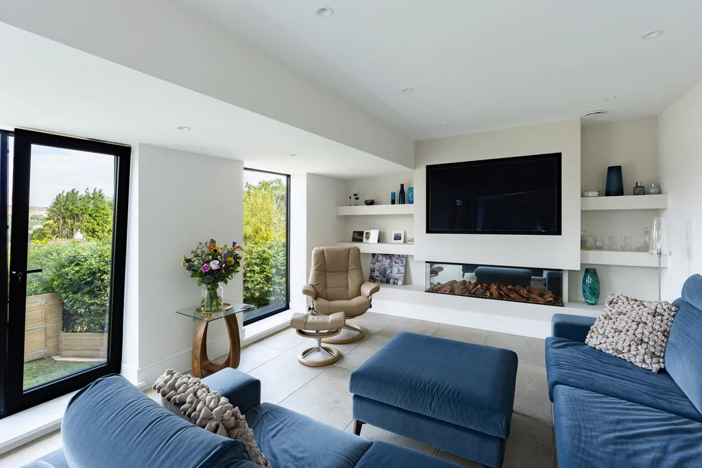Open-plan living room with blue sofa and picture windows
