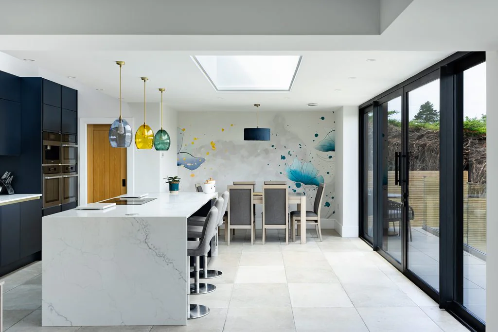 Kitchen with marble island, skylight and garden doors