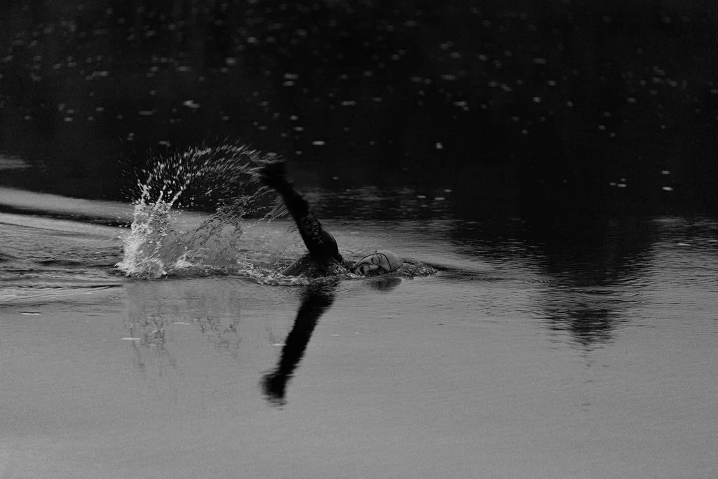 Open-water swimmer mid-stroke, black and white