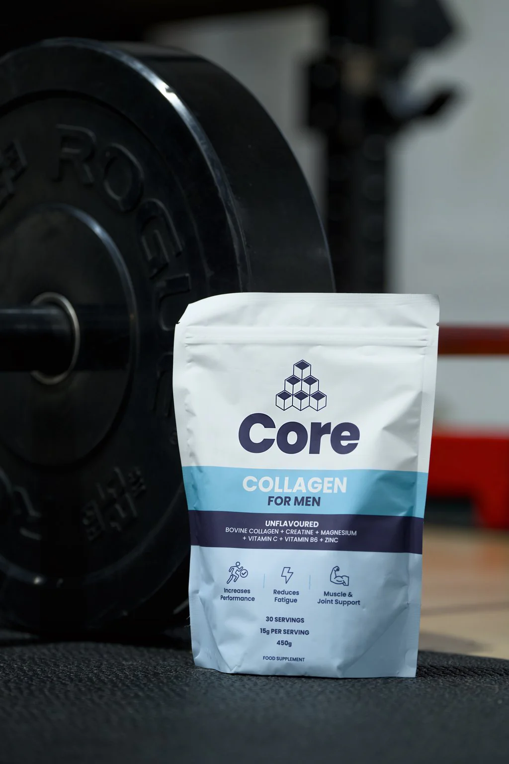 Supplement pouch beside a weight plate in a gym