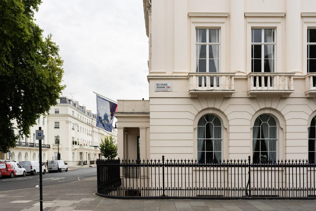 White stucco terrace with columns and railings, photographed for a listing