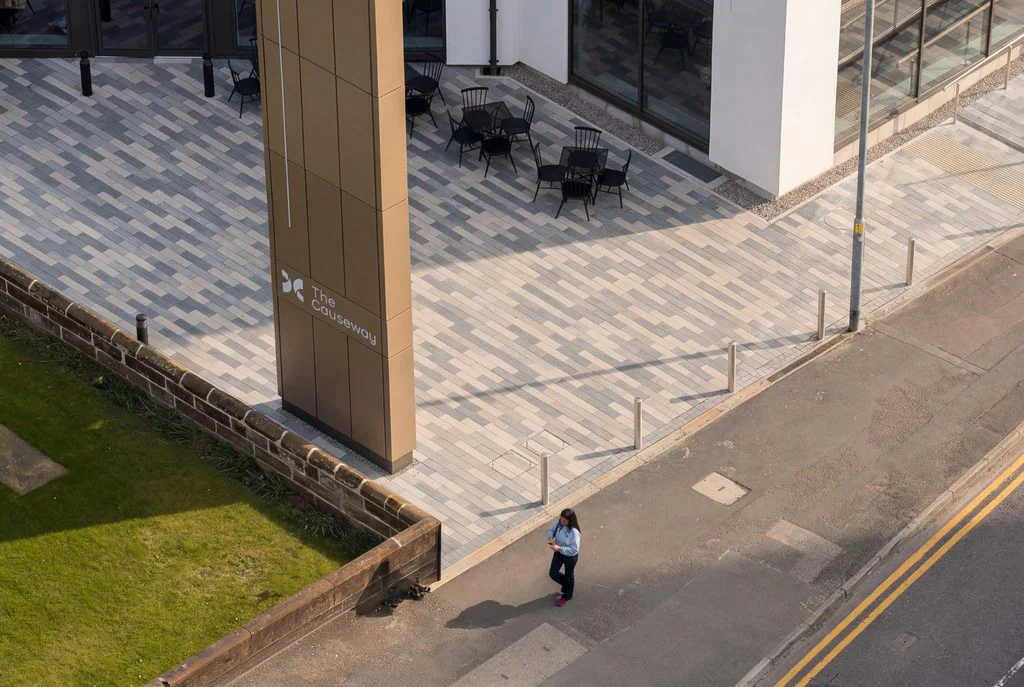 Aerial view of a paved courtyard beside an office building