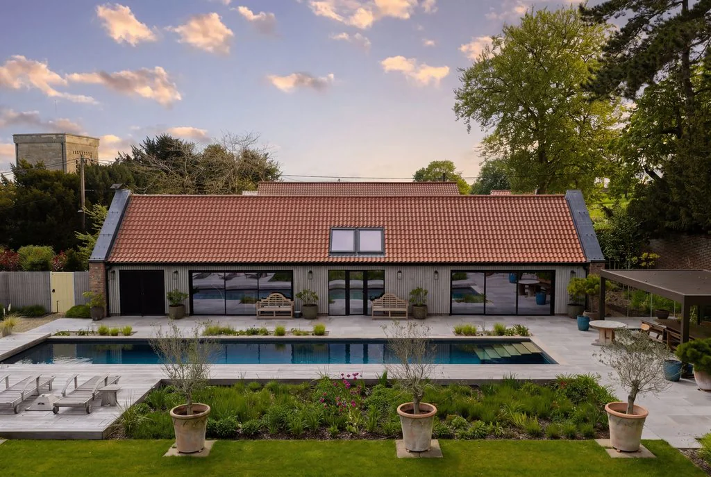 Pool house and swimming pool at sunset