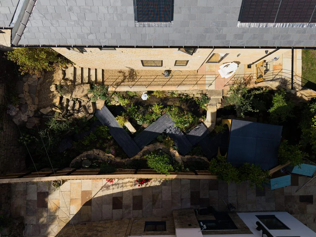 Aerial view of a landscaped garden and house roof
