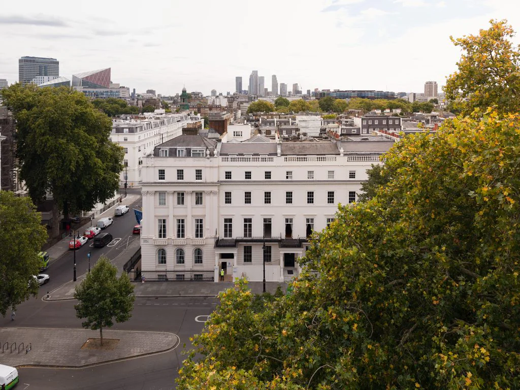 Aerial view of London townhouses with the city skyline