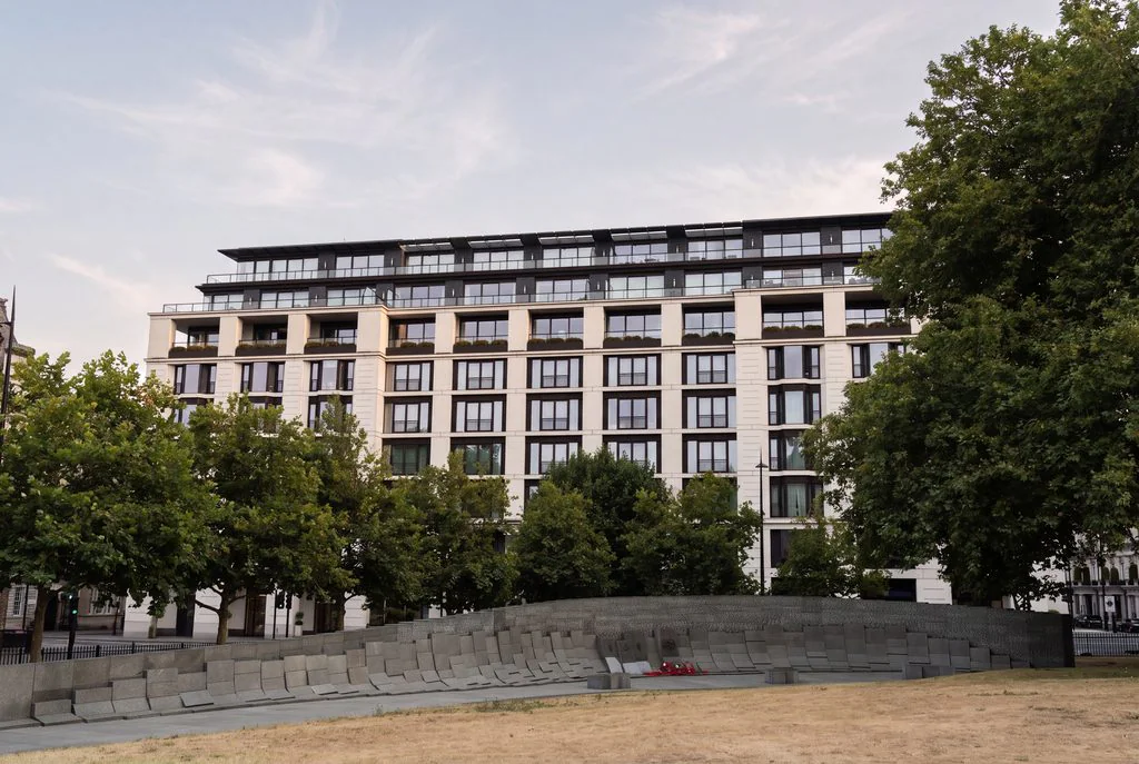 Modern residential block with a lawn and trees, the kind of scheme a launch is built around