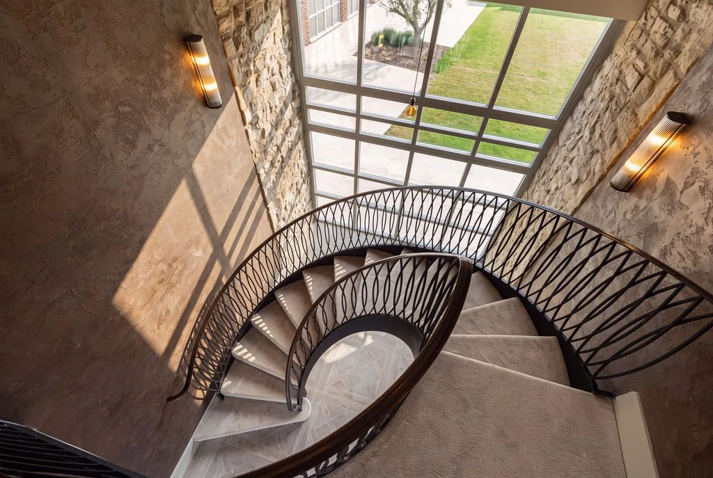 Curved staircase with iron balustrade