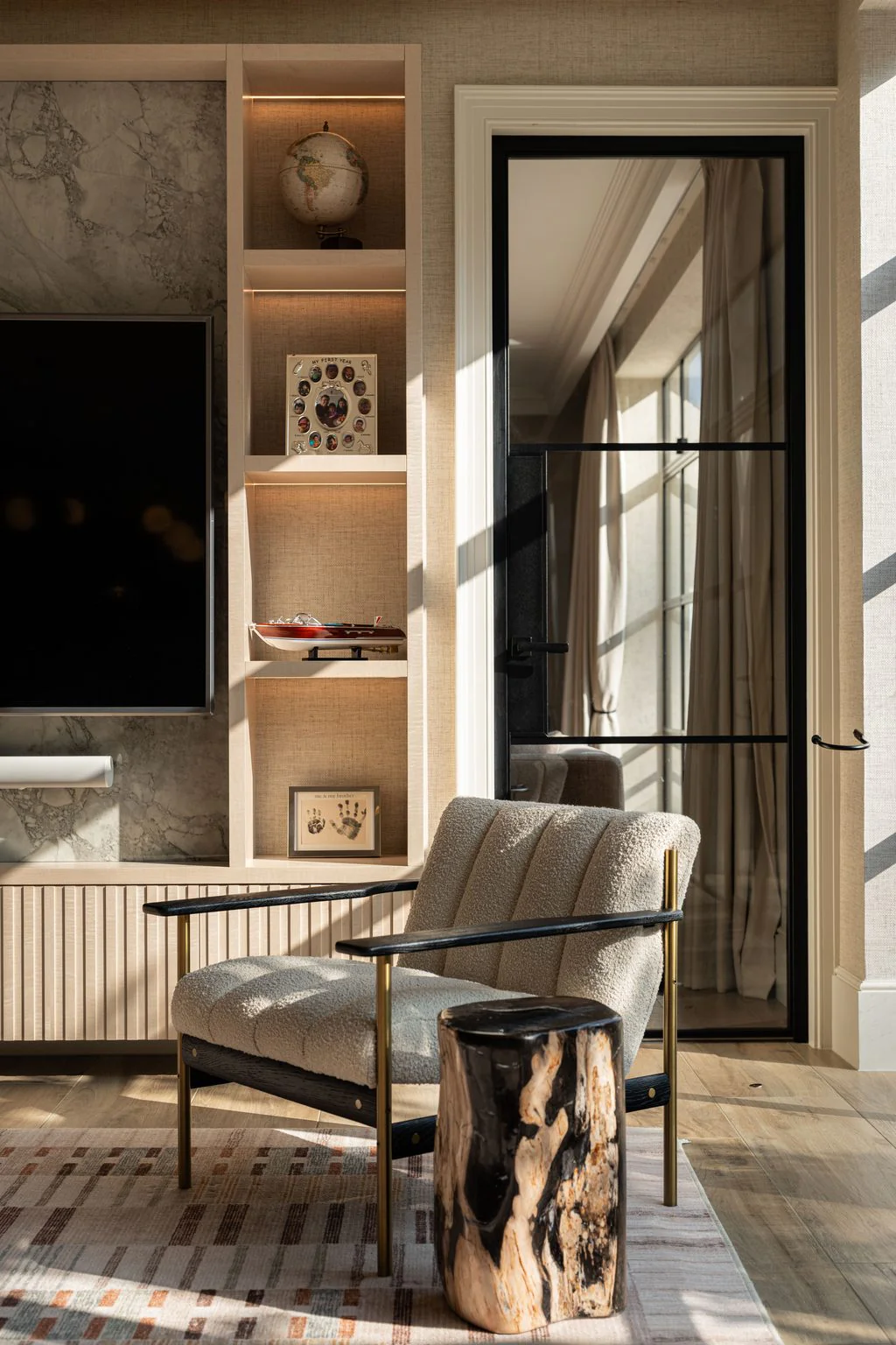 Sitting area with armchair and fitted shelving