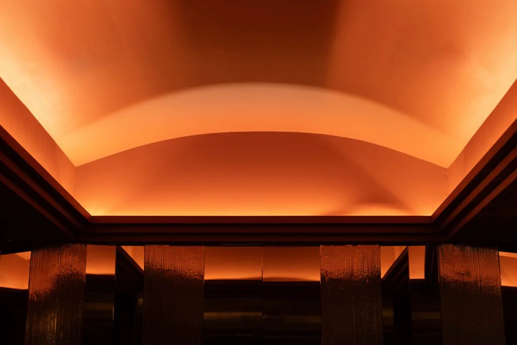 Vaulted ceiling washed in orange light