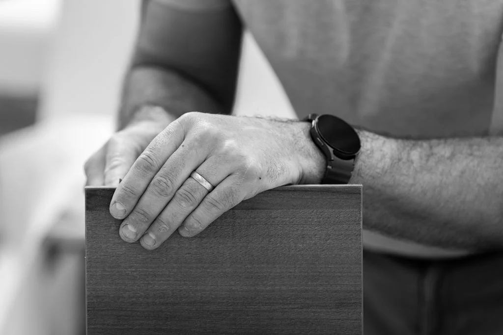 Hands on a steel bar, black and white