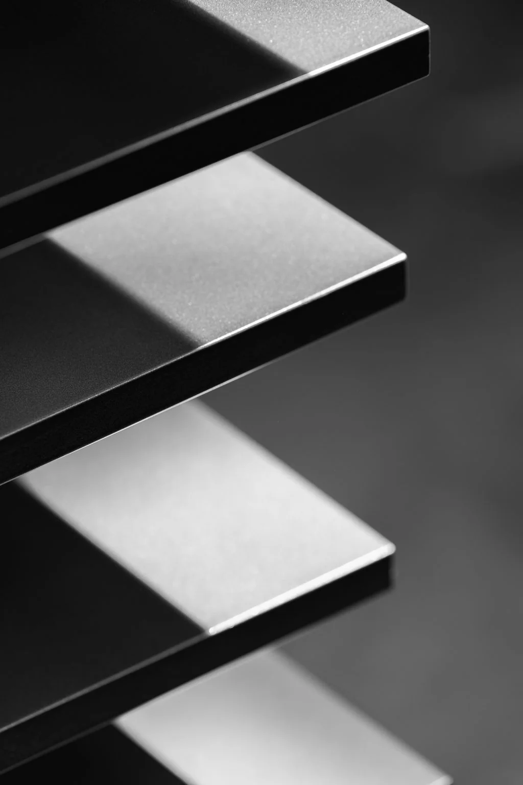 Stacked steel brackets, black and white