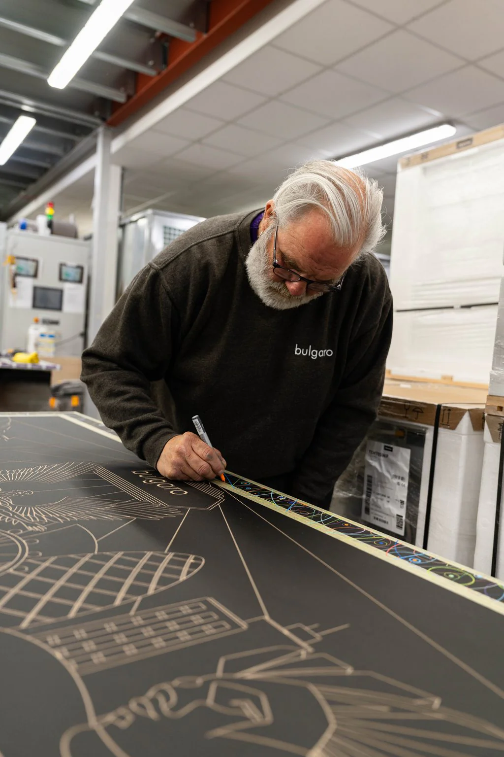 Craftsman marking out a stone slab in the workshop