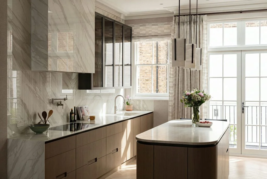 Kitchen with marble island and pendant lights