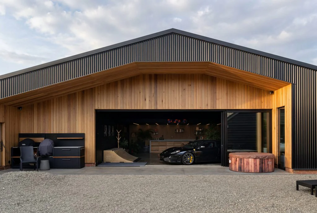 Timber-clad barn with open garage
