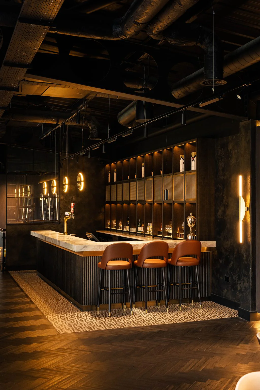 Dark bar with backlit shelving, photographed on a restaurant photo day