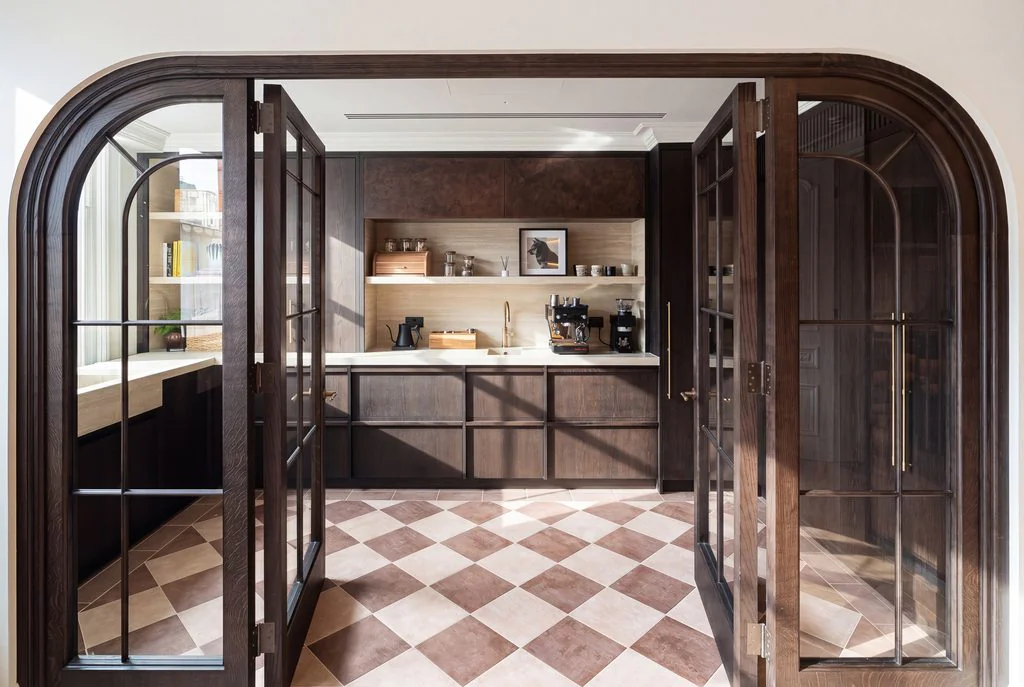 Arched doorway to a kitchen with checkerboard floor