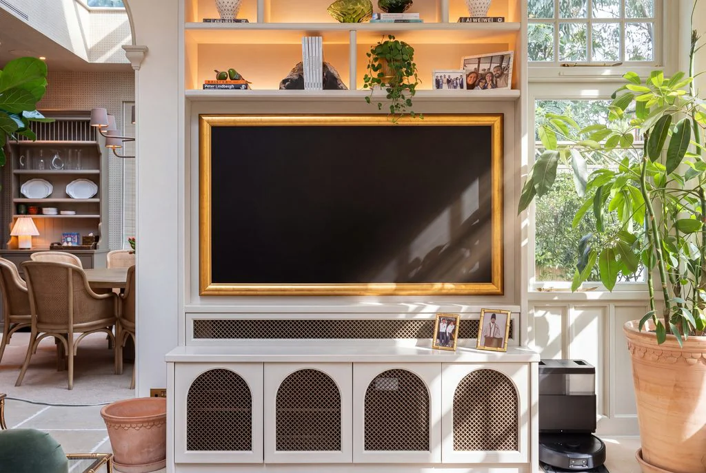 Living room with fitted TV cabinet and plants