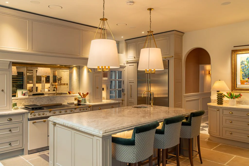 Cream kitchen with island and pendant lamps