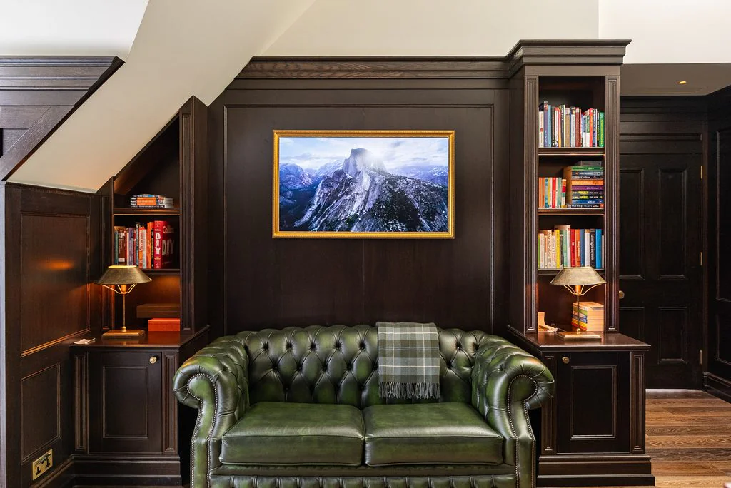 Study with green chesterfield and bookshelves